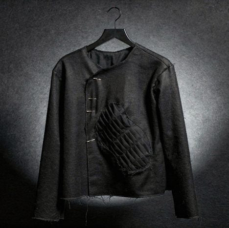 Jacket, prompted the physics — raw edges, waffle-quilt patch, construction intact